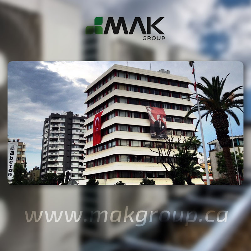 Multi-storey building with balconies and palm trees